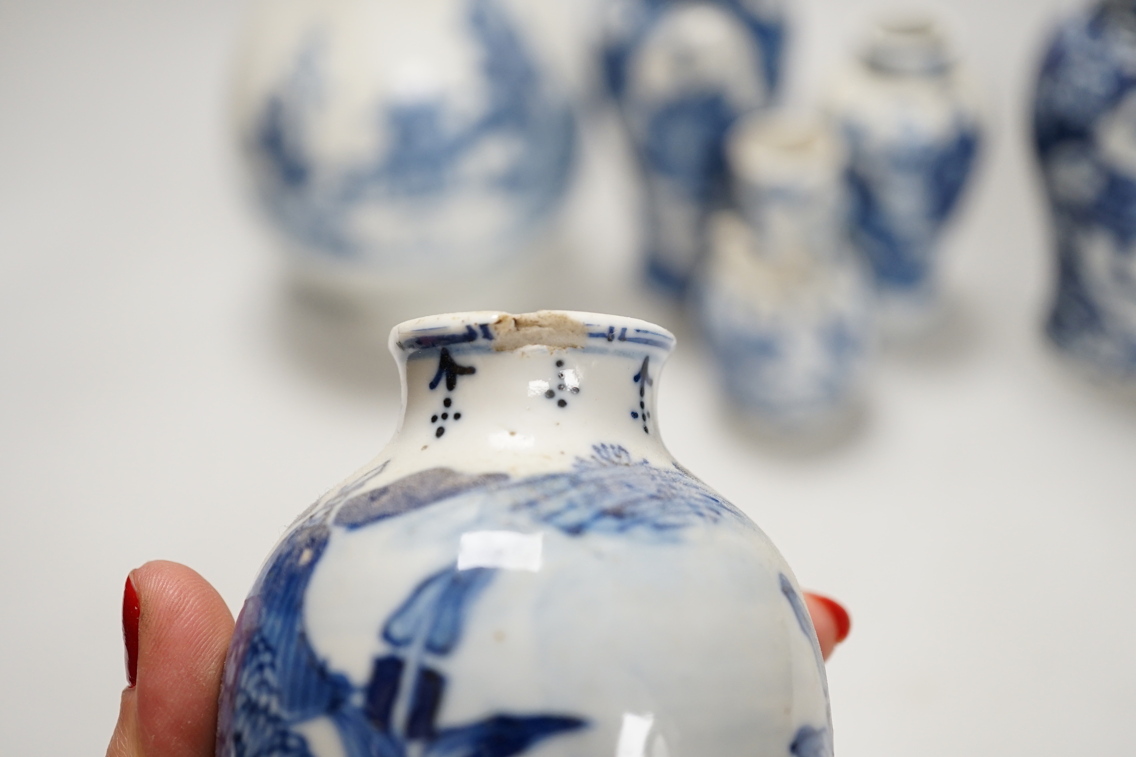 A Chinese armorial blue and white bottle vase, Qianlong/Jiaqing period, and five assorted 19th century Chinese blue and white vases, tallest 20cm; faults